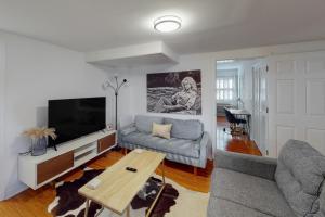 a living room with a couch and a tv at Time to Chill in Nashville