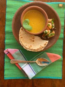 a bowl of soup and a plate of food with a sandwich at Sahana Safari Eco Retreat in Buttala