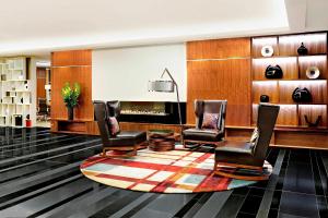 a lobby with three chairs and a fireplace at Sheraton Grand Hotel & Spa in Edinburgh