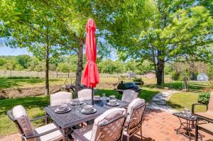 a patio with a table with a red umbrella at 3BR 2BATH Gorgeous Country Near Nashville F1 in Franklin