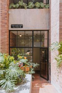 an entrance to a building with plants in front of it at The Somos Flats Laureles in Medellín