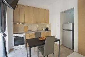a small kitchen with a table and a refrigerator at Stylish Central 2 in Athens