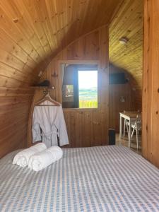 a bedroom with a bed in a wooden cabin at Stoneymollan over Loch Lomond in Balloch
