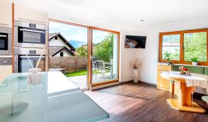 a kitchen with a table and a large window at Traunstein Apartment Aleksandra in Altmünster