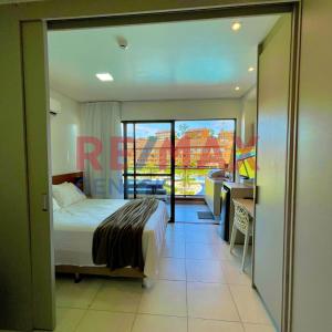 a bedroom with a bed and a view of a balcony at 207 EM Eco Resort in Tamandaré +28 photos