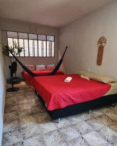a bedroom with two beds with hammocks in it at Espaço Jardim Secreto Hostel in João Pessoa