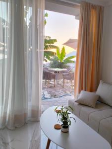 a living room with a couch and a table at Holliday Tivat in Peani