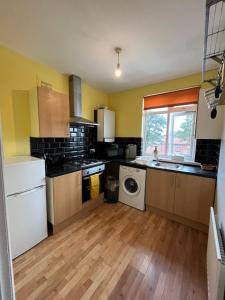 a kitchen with a washer and dryer in it at 2 bedroom apartment, 5 minutes from city centre in Newcastle upon Tyne