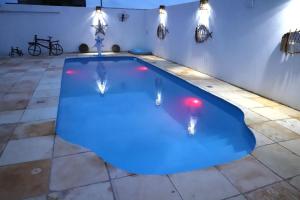 a swimming pool in a house with lights on it at Canoa Quebrada House in Canoa Quebrada