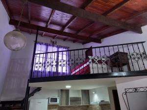 a room with a spiral staircase with a balcony at Aire de mar in Mar del Plata