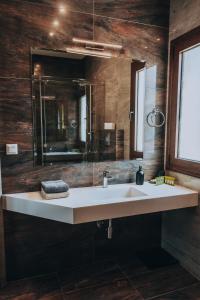 a bathroom with a white sink and a mirror at Epavli Alexandros Luxury Villa in Vourvourou