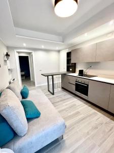 ein Wohnzimmer mit einem Sofa und einer Küche in der Unterkunft T21 Holiday in Bergamo