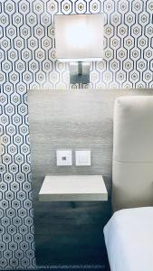 a bedroom with a bed and a desk with a tv at Kyriad Direct Laon in Laon
