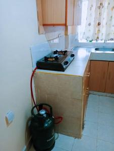a kitchen with a stove on top of a counter at WIMS in Kakamega