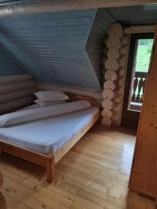 a bedroom with a bed in a attic at Cabana Haiducului in Soveja