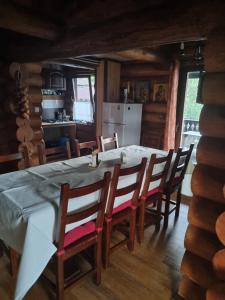 a kitchen and dining room with a table and chairs at Cabana Haiducului in Soveja +22 photos