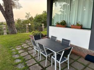 a black table and chairs on a patio at Villa Roccia Scura dell'Etna in Zafferana Etnea