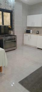 - une cuisine avec des appareils électroménagers blancs et un sol blanc dans l'établissement Villa Bakr, à Alexandrie