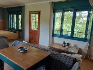 a living room with a table and some windows at Marókahegy in Zalakaros