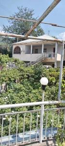 a house on a hill with a fence and a street light at Ijevan beautiful Home in Ijevan