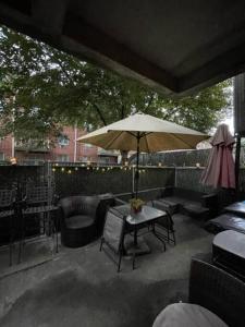 a patio with a table and an umbrella and chairs at Brooklyn Luxury Spring Retreat with Private Outdoor Space in Brooklyn