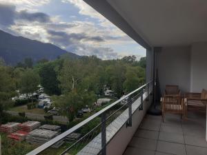 a balcony with a view of a parking lot at Les Picaillons - A 200m du lac in Aix-les-Bains