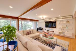 a living room with a couch and a table at Cape Cod Home with Roof Top Deck, Pool and Hot Tub! in Wellfleet