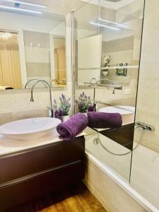 a bathroom with a sink and a glass shower at Luxury 130m2 AC, Terrace, Pool, Parking - Steps to beach, 5 min Palais des Festivals 3BR-3BA in Cannes
