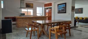 a kitchen and living room with a wooden table and chairs at Hotel & Museo Casa Turquesa in Cancún