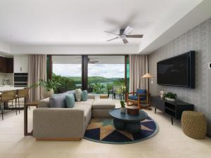 a living room with a couch and a tv at Andaz Costa Rica Resort at Peninsula Papagayo – A concept by Hyatt in Culebra