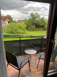 a balcony with chairs and a table and a window at FMA Ferienwohnung Alfdorf in Alfdorf