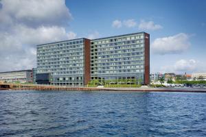 a large building next to a large body of water at Copenhagen Marriott Hotel in Copenhagen
