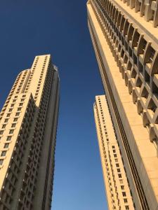 two tall buildings standing next to each other at Skyview City Apartment in Skopje