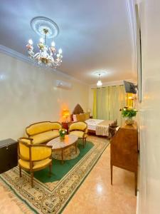 a living room with yellow chairs and a couch at Dar Baddi in Marrakesh