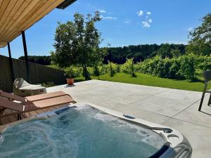 a hot tub in a yard with a patio at Lind Fruchtreich in Sebersdorf