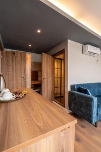 a kitchen with a wooden table and a blue couch at The Han Residence Haliç in Istanbul