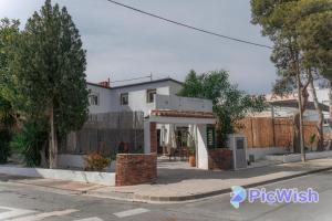 a house on the corner of a street at La Siesta Hostel in Almarda