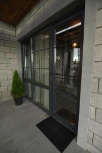 a glass door of a house with a potted plant at Guest House in Gyumri