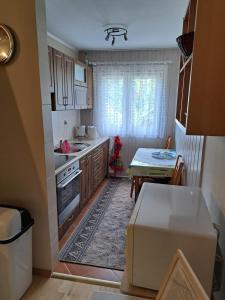 a small kitchen with a table and a dining room at Domek letniskowy Werlas Bieszczady in Werlas