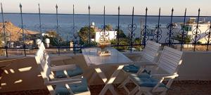 a table and chairs on a balcony overlooking the ocean at Lentas Royal in Lentas