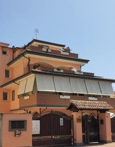 a building with a fence in front of it at Guest House Brezza Marina in Fiumicino