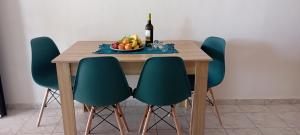 a table with a bowl of fruit and a bottle of wine at Lentas Royal in Lentas