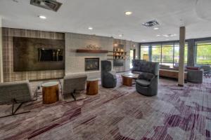a lobby with couches and chairs and a fireplace at Courtyard by Marriott Memphis Southaven in Southaven