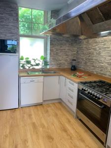 a kitchen with white cabinets and a stove top oven at Chandlers Country House in Rothesay