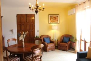 a living room with a table and chairs at Casa Luisa in Pitigliano