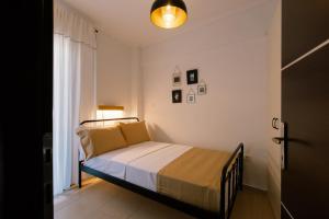a bedroom with a bed in a room at Upper city suite in Thessaloniki