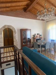 a living room and dining room with a blue couch at Superior Stone in Venetico