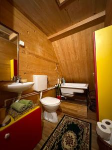 a wooden bathroom with a toilet and a sink at Household Jakic in Pljevlja