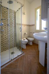 a bathroom with a shower and a toilet and a sink at Casa Francesco in Pizzo