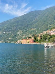 a large body of water with a town on a mountain at Le allodole in Bellano